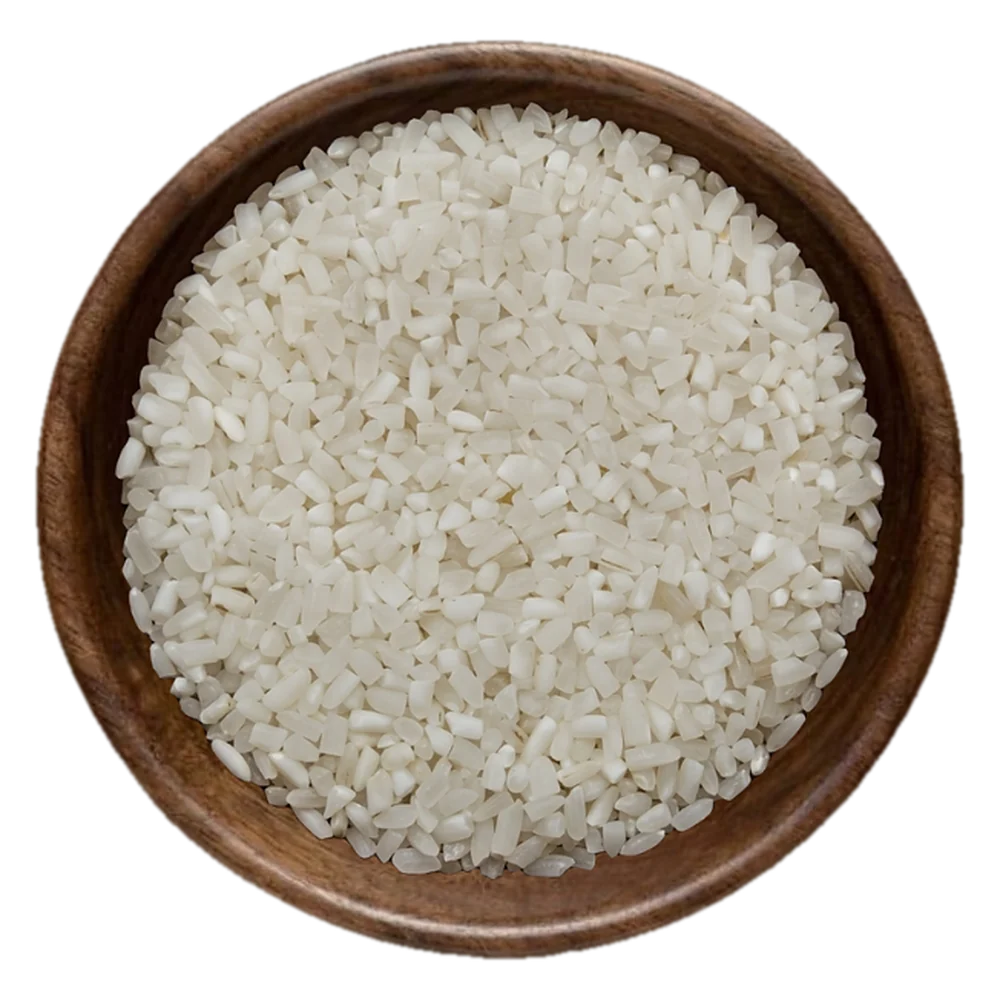 Close view of 100% broken Rice in a wooden bowl, seen from above