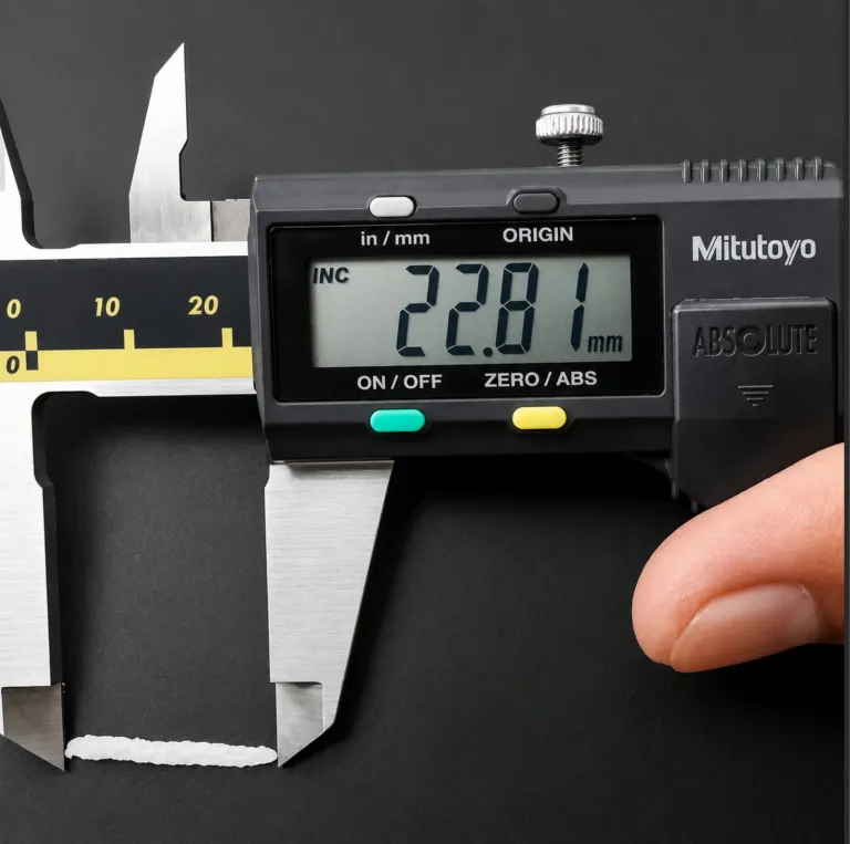 A cooked Rice grain measured at 22.81 mm on a digital caliper, the elongation check