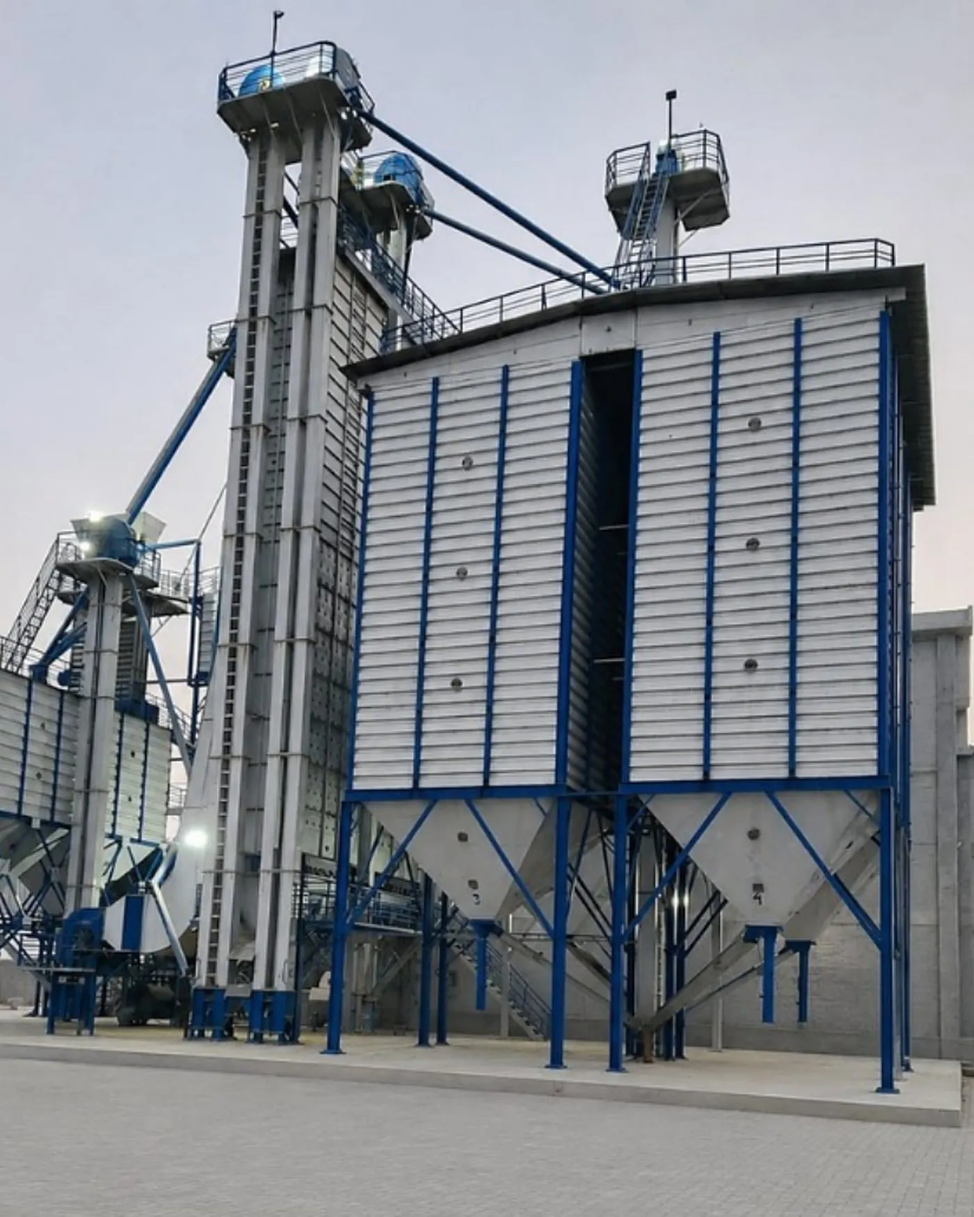 Paddy silos and bucket elevators at a Green International Rice mill