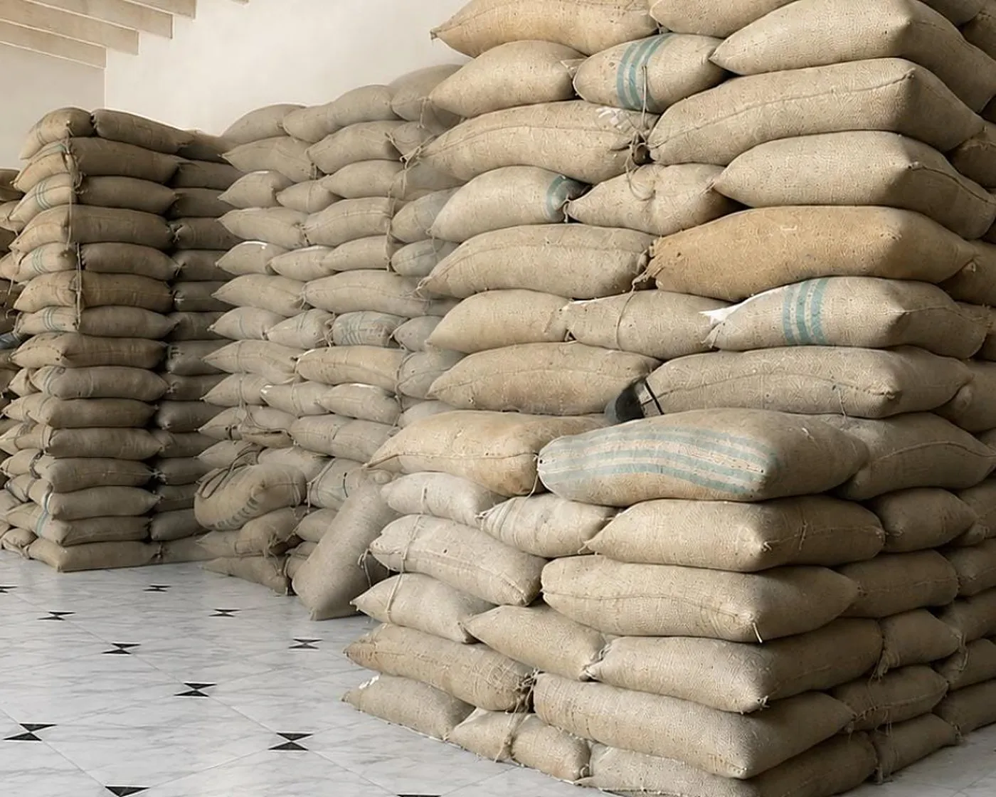 Filled bags stacked in the warehouse, each one weighed on the line before it got there