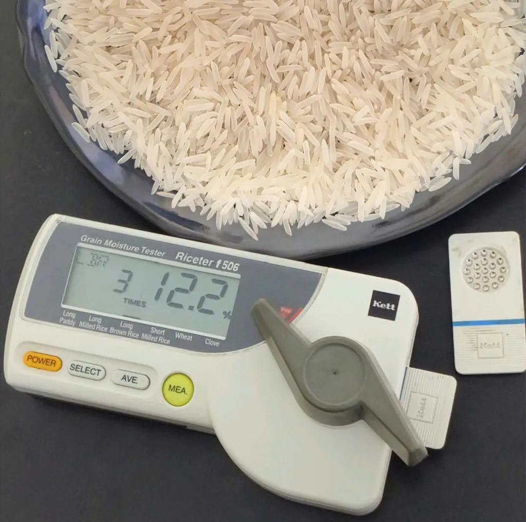A Kett Riceter grain moisture tester reading 12.2 percent on a milled Rice sample