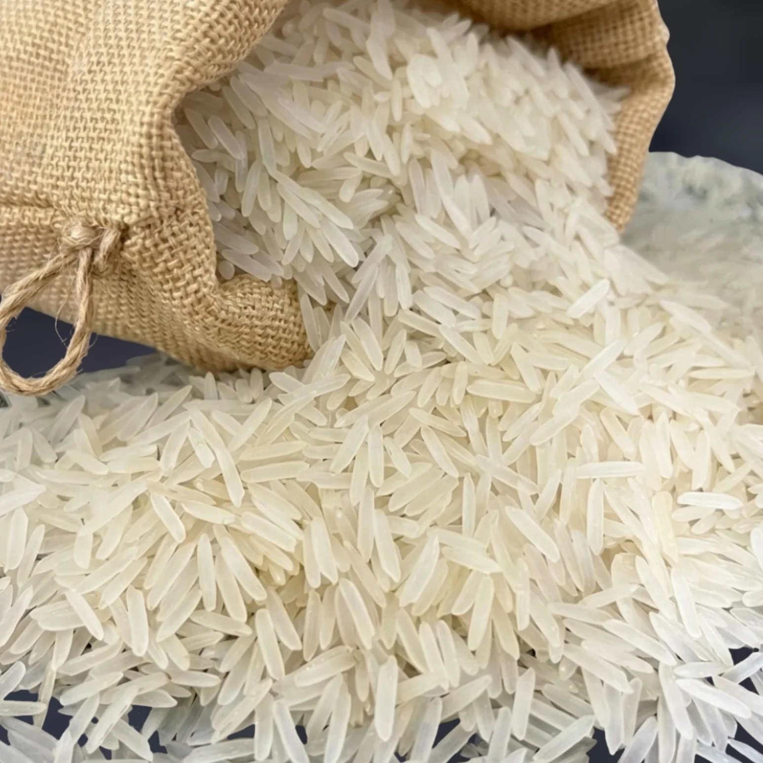 Long, slender Basmati Rice grains spilling from a jute sack
